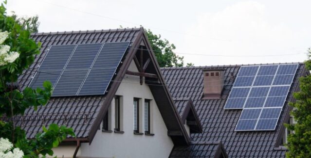 Two houses with solar panels on their roofs